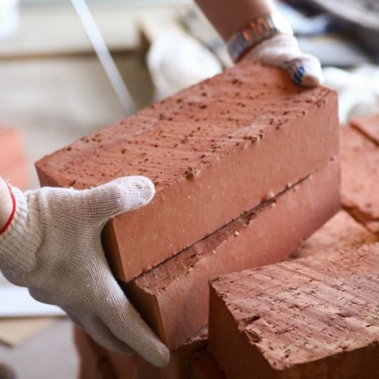 Photo is of a bricklayer carrying bricks in Newcastle Photo is of a bricklayer carrying bricks in Newcastle