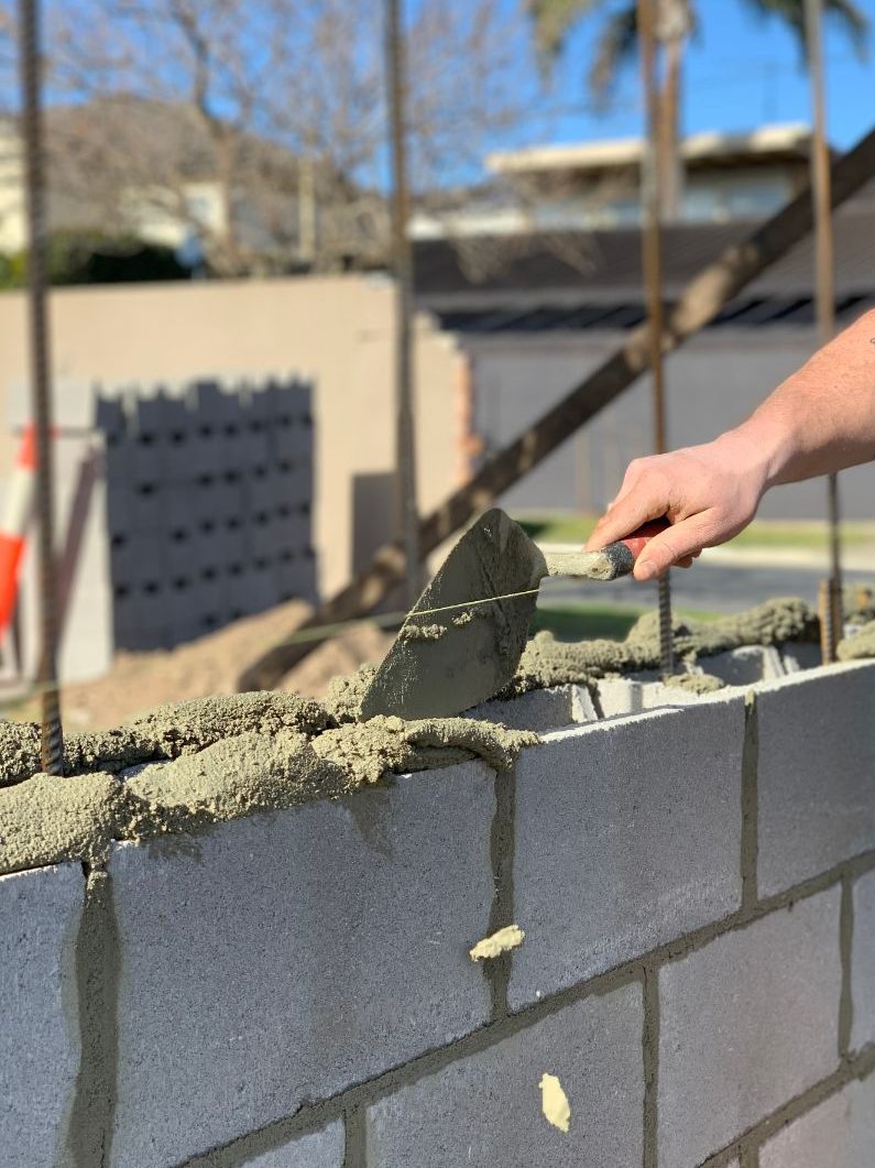 Newcastle Bricklayers Bricklaying laying blocks on a fence in Newcastle